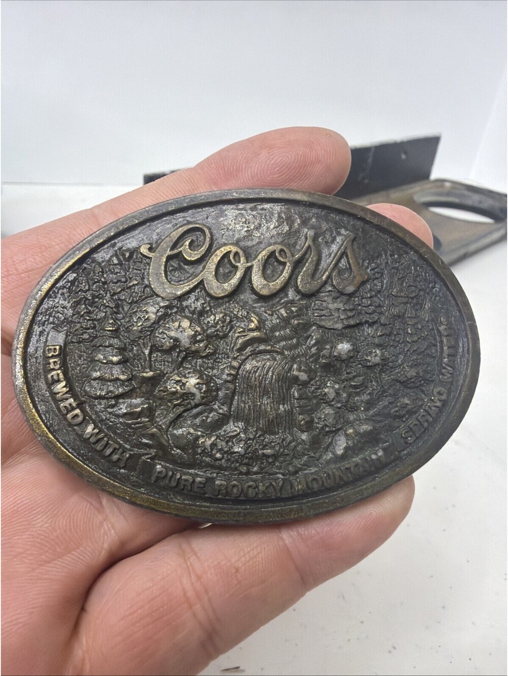 vintage COORS brass belt buckle with botle opener on back